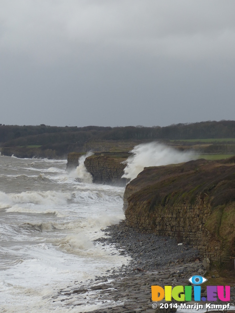 LZ00676 Waves crashing against cliffs at Llantwit Major beach